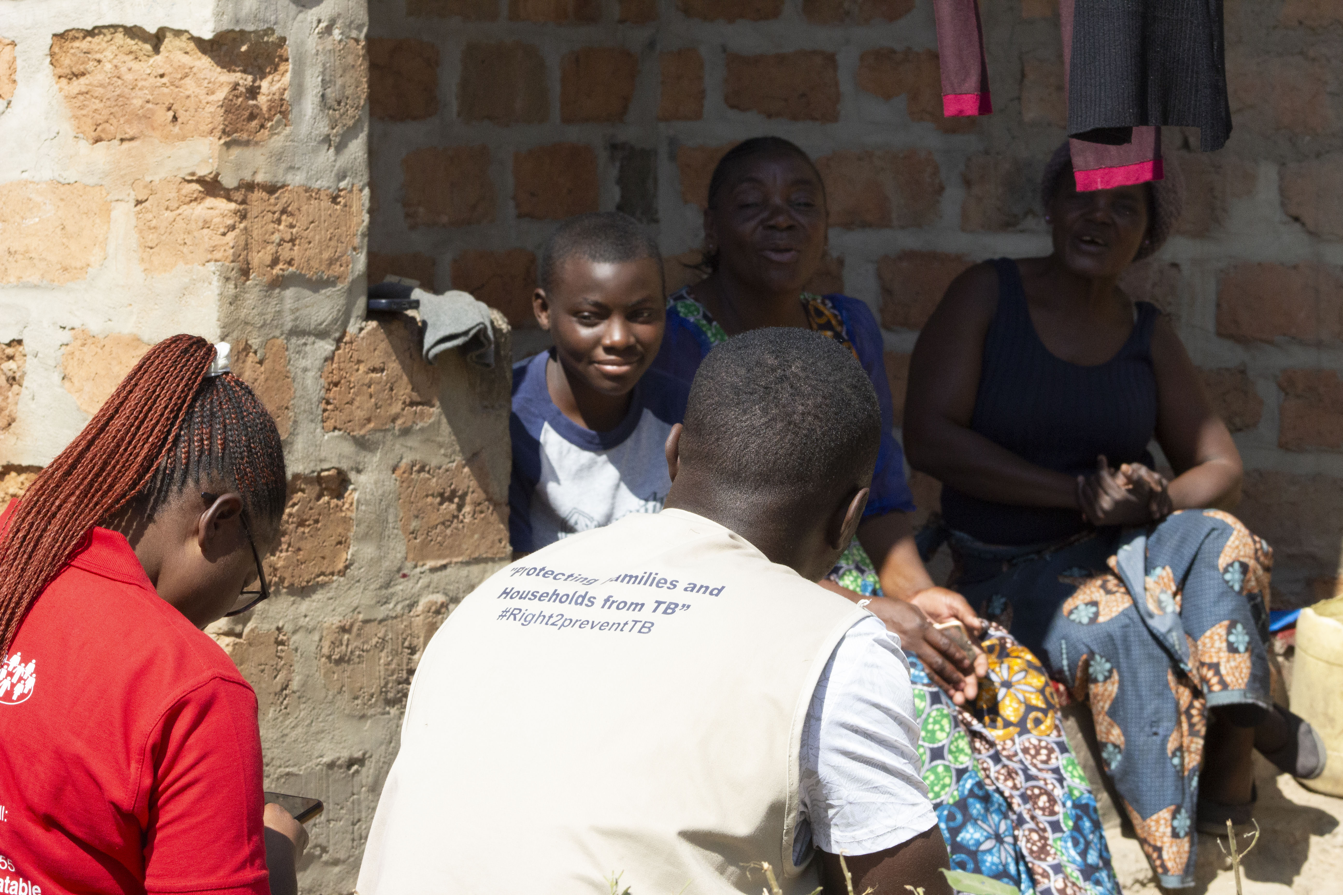 Maxwell Mumba with colleagues and people living with TB at the IMPAACT4TB project in Kabwe District, Zambia.