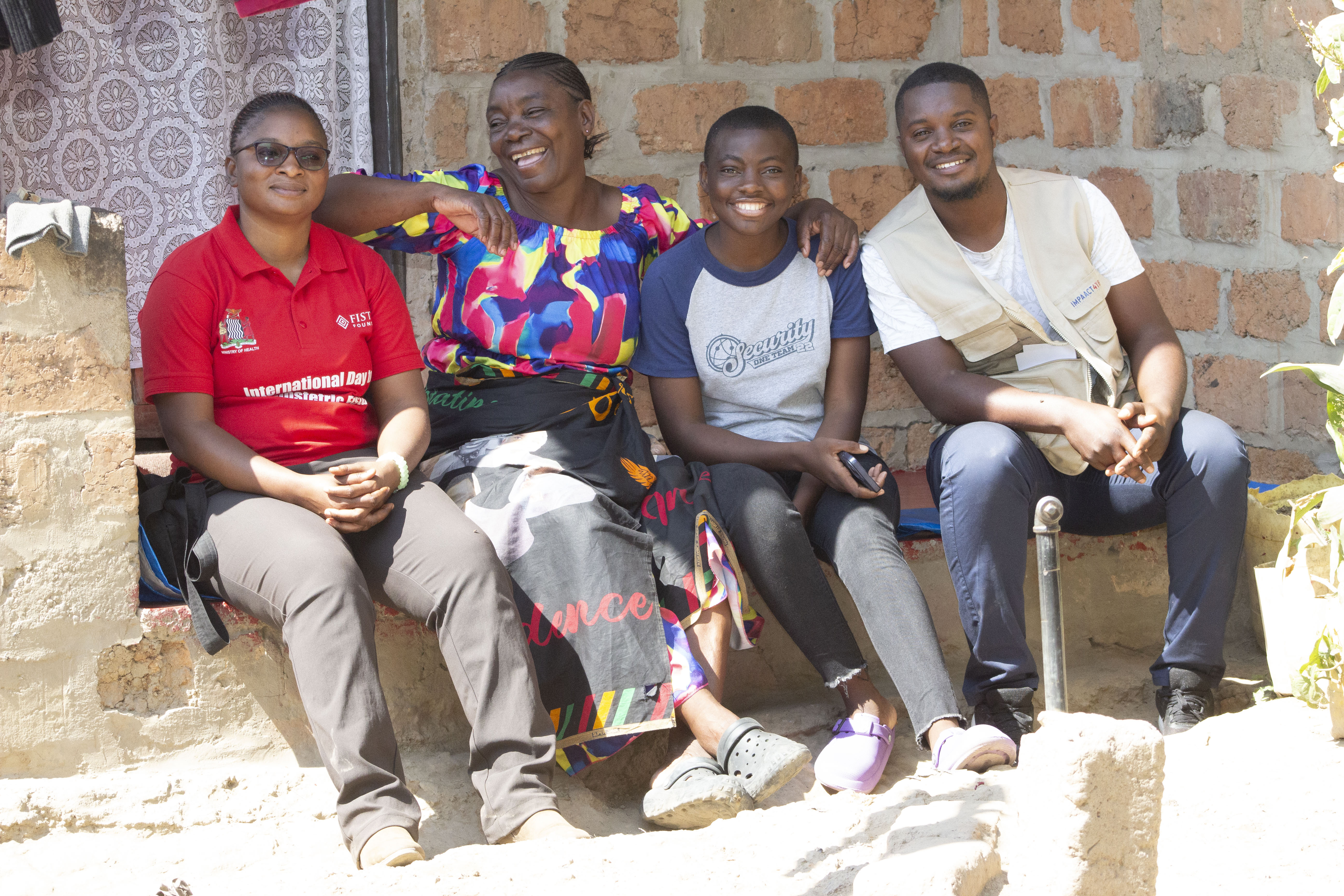 Maxwell Mumba (far right) with Musunga Chitonge (Ministry of Health) at the IMPAACT4TB project site in Makululu compound, Kabwe, Zambia.