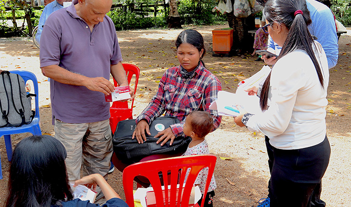 Louis Da Gama reviewing malaria test data with community health workers in Cambodia